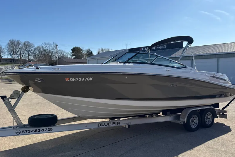 Slide: The Image of 2007 Sea Ray 250 Select EX boat on trailer, parked outdoors under clear sky. - 7