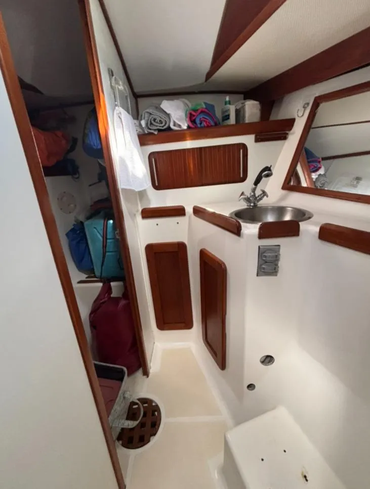 Slide: The Image of Interior of a 1989 Caliber 38 yacht with wooden furnishings. - 13