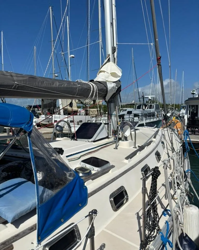 Slide: The Image of 1989 Caliber 38 sailboat docked in marina, sunny day. - 2