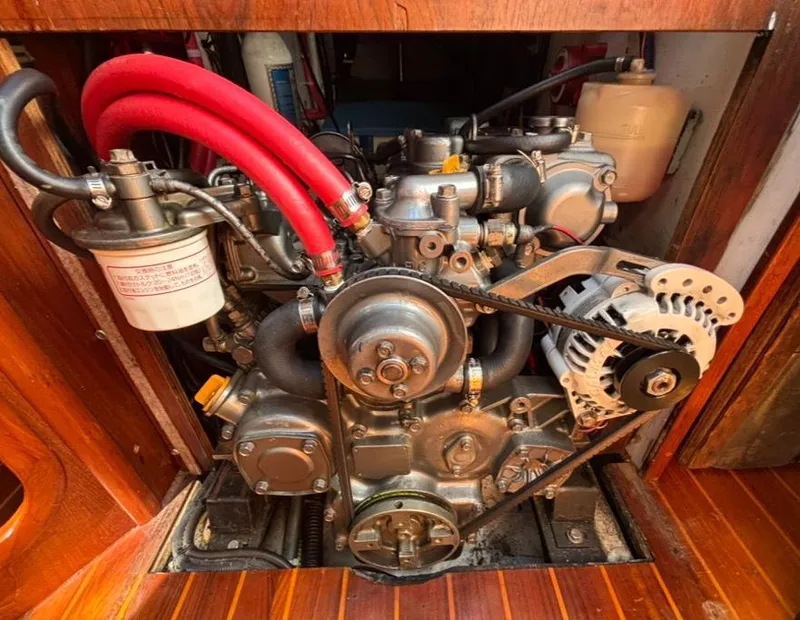 Slide: The Image of 1989 Caliber 38 sailboat engine with red hose. - 22