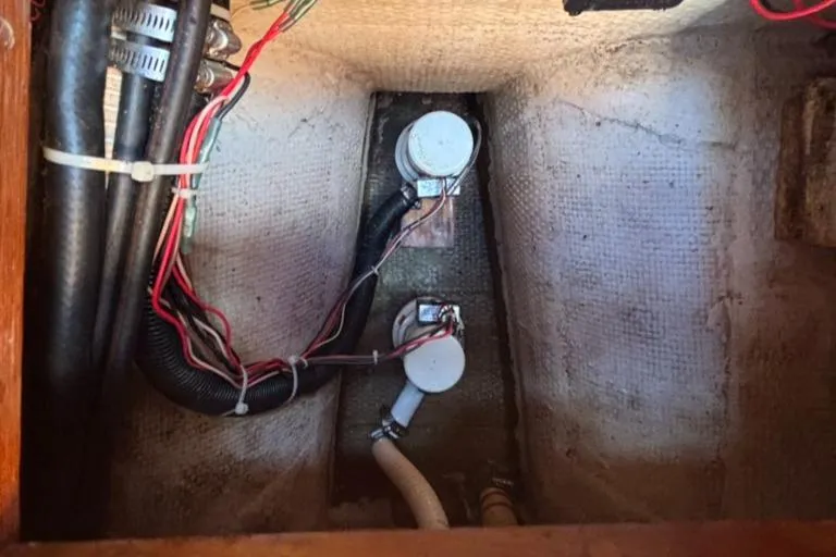 Slide: The Image of Interior view of a 1989 Caliber 38 with wiring and pipes. - 23