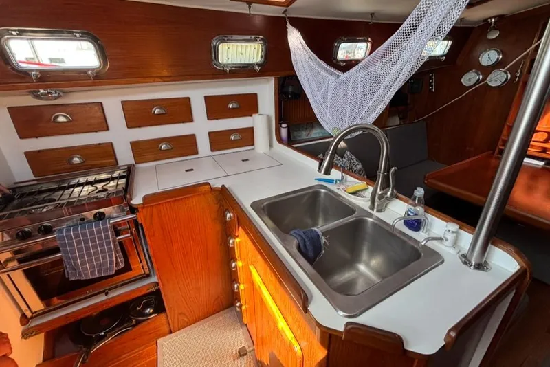 Slide: The Image of 1989 Caliber 38 yacht interior with wooden shelves and wine bottles. - 6