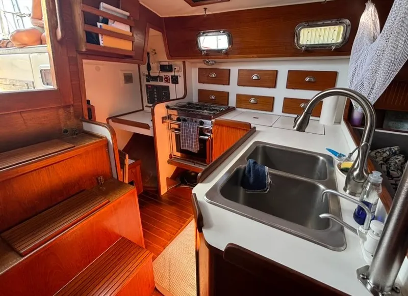 Slide: The Image of Interior of 1989 Caliber 38 sailboat with wood finish and cozy seating area. - 7