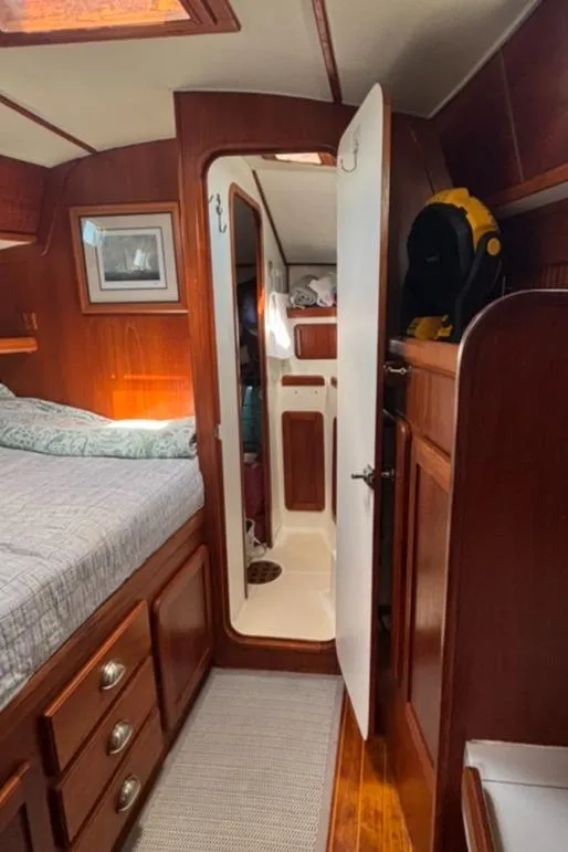 Slide: The Image of Interior of a 1989 Caliber 38 yacht with kitchen and wood paneling. - 9