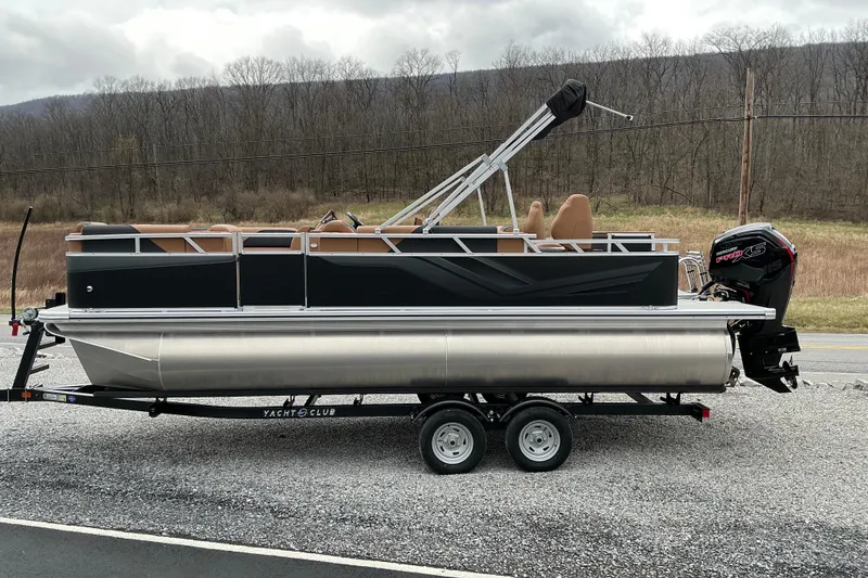 The Image of 2026 Avalon Venture Rear Fish 21' pontoon boat on trailer, parked roadside. - 1