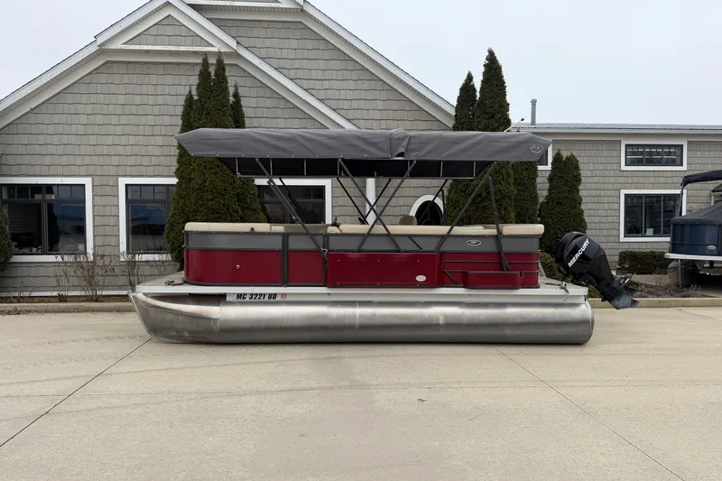 The Image of 2018 Crest I pontoon boat with canopy, parked in front of a house. - 1
