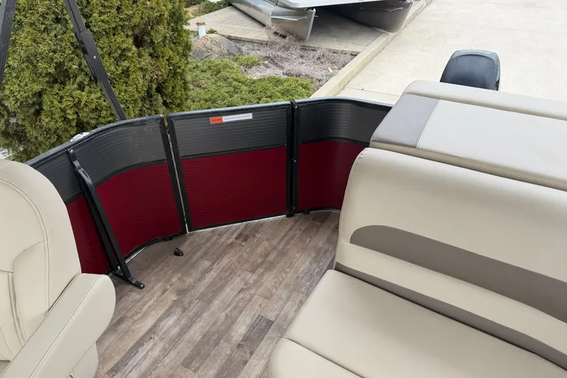Slide: The Image of Interior of a 2018 Crest I pontoon boat with beige seating and wood-style flooring. - 12