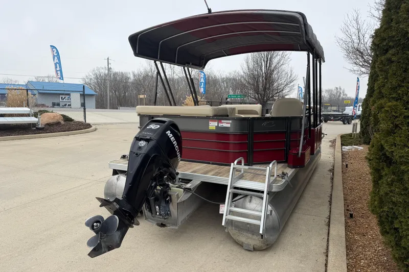 Slide: The Image of 2018 Crest I pontoon boat with Mercury outboard motor, parked outdoors. - 3