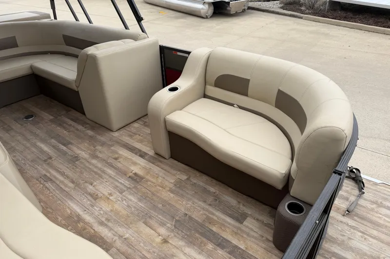 Slide: The Image of 2018 Crest I pontoon boat interior with beige seating and wood-style flooring. - 6