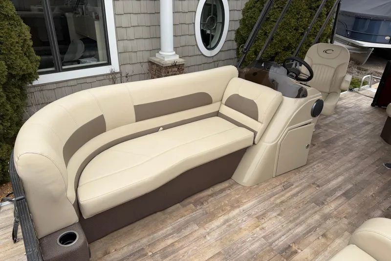 Slide: The Image of 2018 Crest I boat interior with beige seating and wood-style flooring. - 7