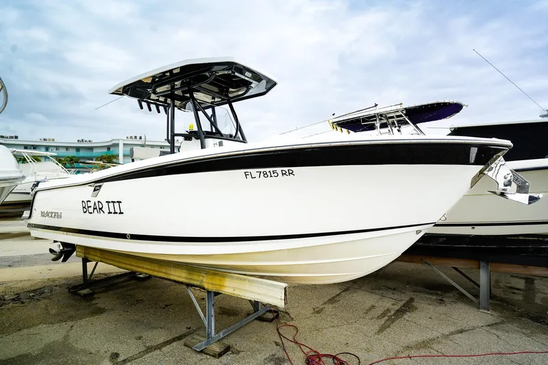 The Image of 2018 Blackfin 242 CC boat named "Bear III" on a trailer, side view. - 1