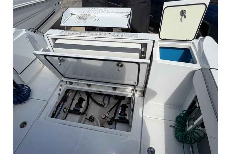 Slide: The Image of 2018 Blackfin 242 CC boat cockpit with steering wheel and control panel. - 10