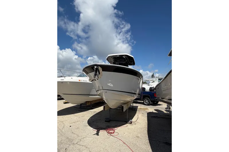 Slide: The Image of 2018 Blackfin 242 CC boat interior with steering console and seating area. - 12