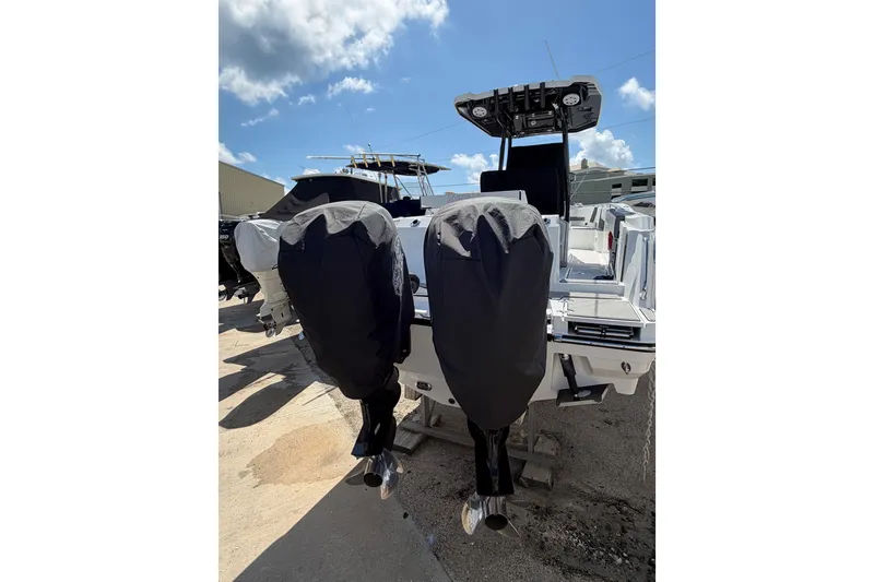 Slide: The Image of 2018 Blackfin 242 CC boat dashboard with steering wheel, controls, and navigation equipment. - 13