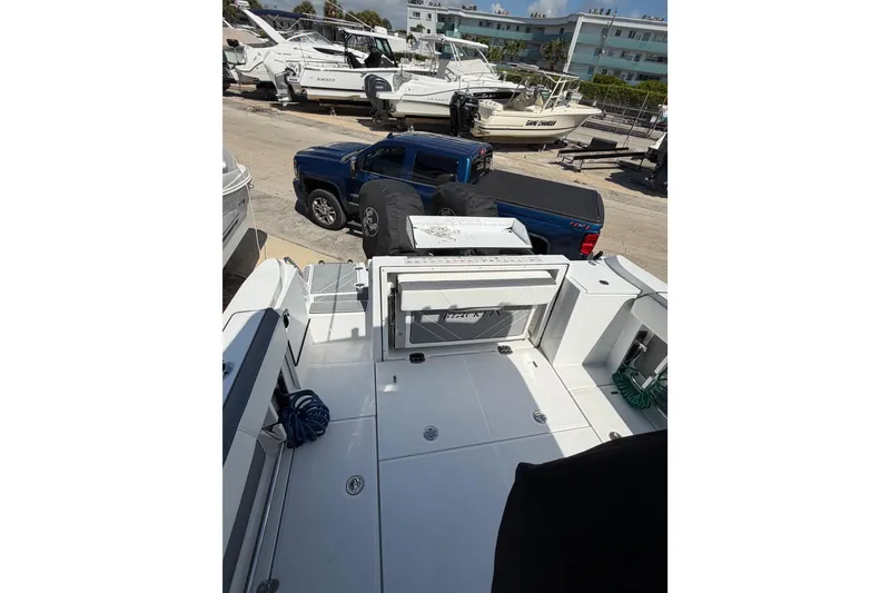 Slide: The Image of 2018 Blackfin 242 CC boat dashboard with steering wheel and navigation controls. - 14