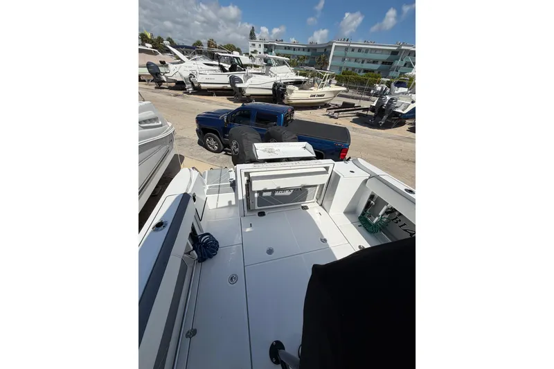 Slide: The Image of 2018 Blackfin 242 CC boat interior with cushioned seating and sleek design. - 15