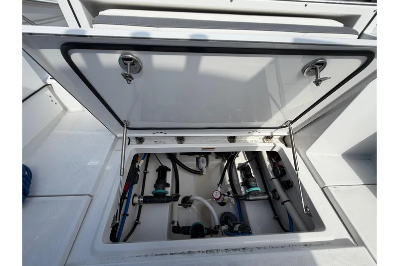 Slide: The Image of 2018 Blackfin 242 CC boat docked among other vessels at a marina. - 20