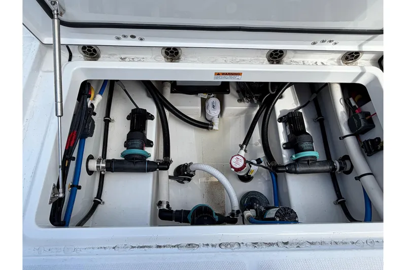 Slide: The Image of Interior of 2018 Blackfin 242 CC boat featuring a compact marine toilet. - 21