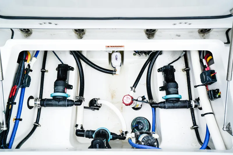 Slide: The Image of 2018 Blackfin 242 CC boat plumbing system with hoses and pumps. - 24