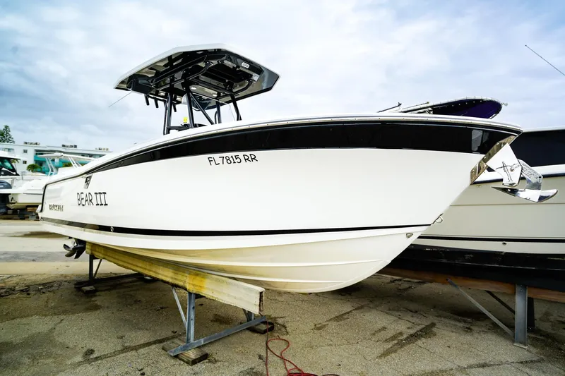 Slide: The Image of 2018 Blackfin 242 CC boat on trailer, side view with overcast sky. - 25
