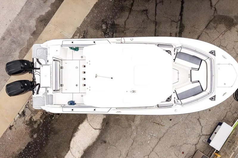 Slide: The Image of Overhead view of a 2018 Blackfin 242 CC boat with dual engines on a concrete surface. - 3