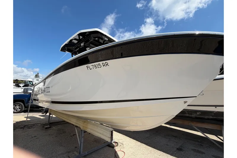 Slide: The Image of 2018 Blackfin 242 CC boat interior with modern console and seating, docked at marina. - 6