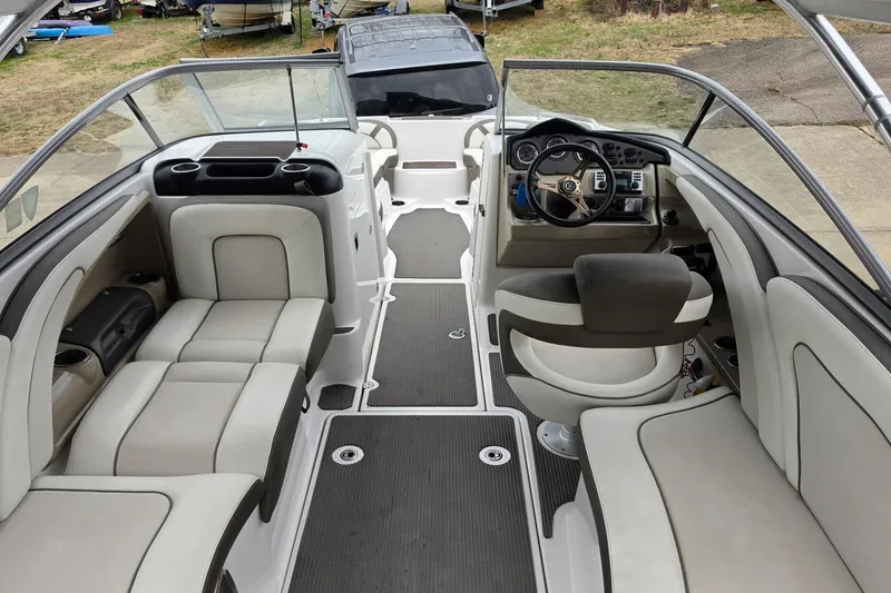 Slide: The Image of 2014 Yamaha Boats 242 Limited interior with seating and steering console. - 11