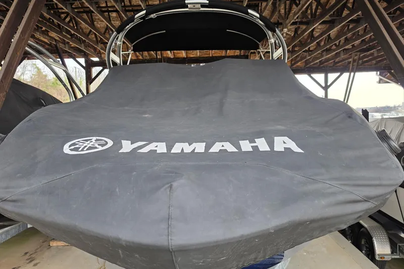 Slide: The Image of Covered 2014 Yamaha Boats 242 Limited under a shelter. - 13