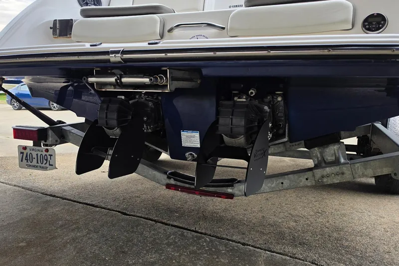 Slide: The Image of Rear view of a 2014 Yamaha Boats 242 Limited on a trailer, showcasing dual engines. - 5