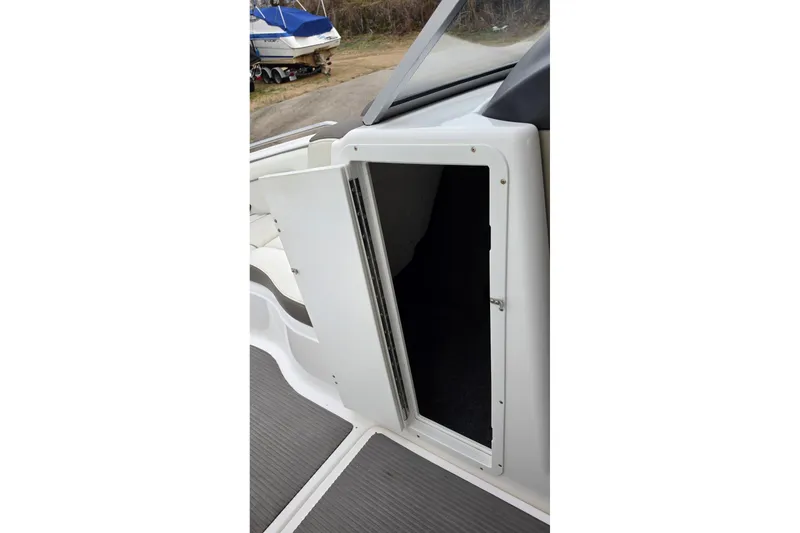 Slide: The Image of Open storage compartment on a 2014 Yamaha Boats 242 Limited. - 6