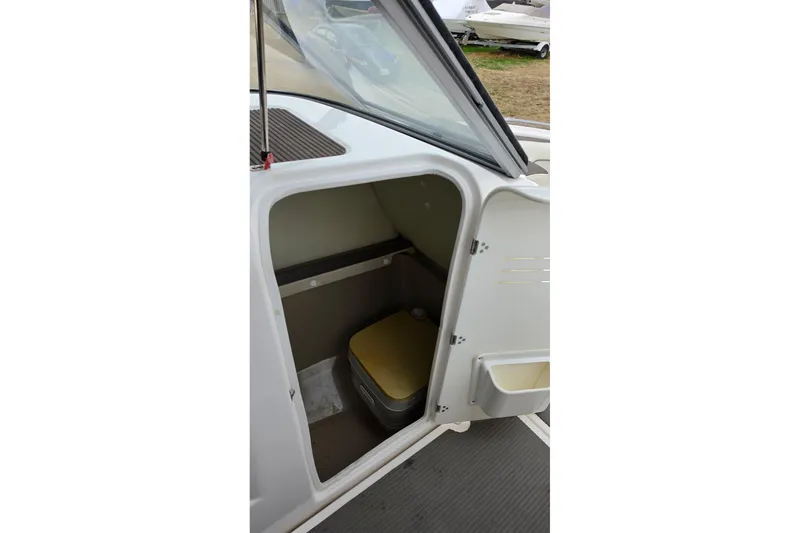 Slide: The Image of 2014 Yamaha Boats 242 Limited interior cabin with portable toilet. - 7