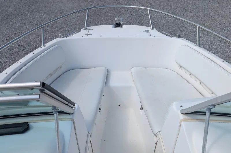 Slide: The Image of 1998 Boston Whaler Ventura 20 boat interior with white seating and railing. - 5
