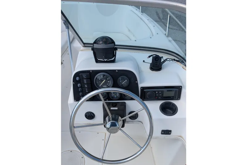 Slide: The Image of Steering console of a 1998 Boston Whaler Ventura 20 boat with gauges and controls. - 7