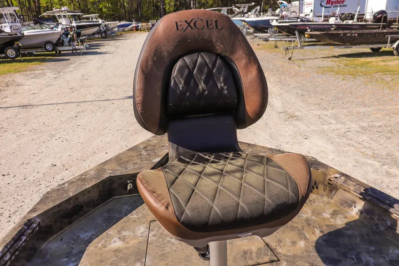 Slide: The Image of 2026 Excel 203 Bay Pro Elite boat seat in a marina setting. - 14