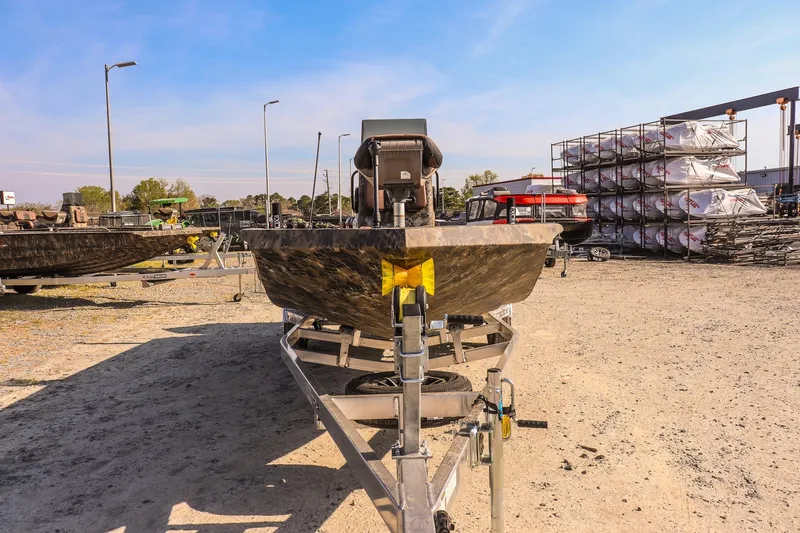 Slide: The Image of 2026 Excel 203 Bay Pro Elite boat on trailer in outdoor lot. - 2