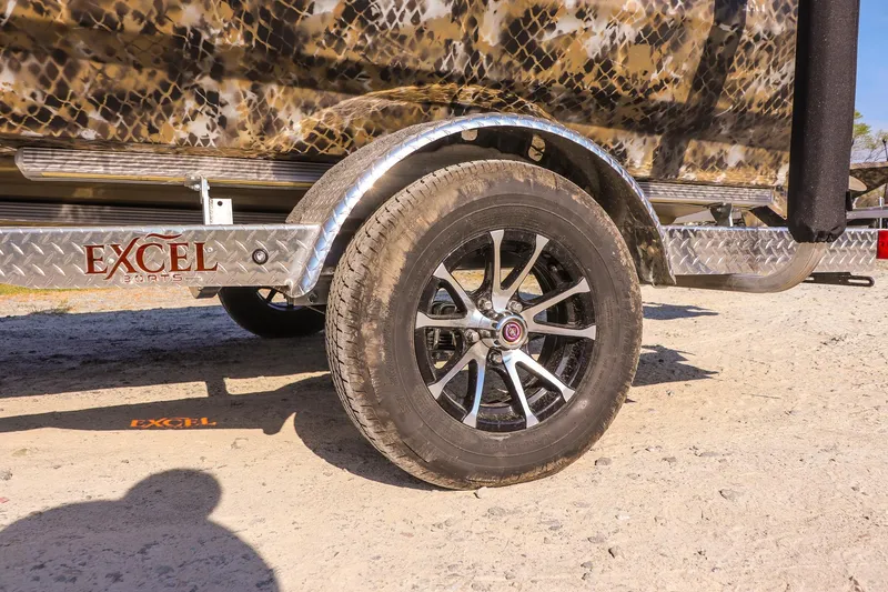 Slide: The Image of Trailer wheel of 2026 Excel 203 Bay Pro Elite on sandy terrain. - 9