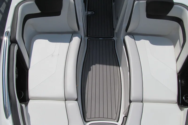 Slide: The Image of 2018 Yamaha Boats 242 Limited S interior seating, featuring sleek white upholstery and modern design. - 12