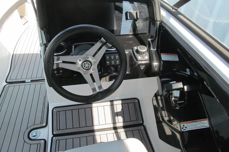 Slide: The Image of 2018 Yamaha Boats 242 Limited S steering console with modern controls and sleek design. - 8