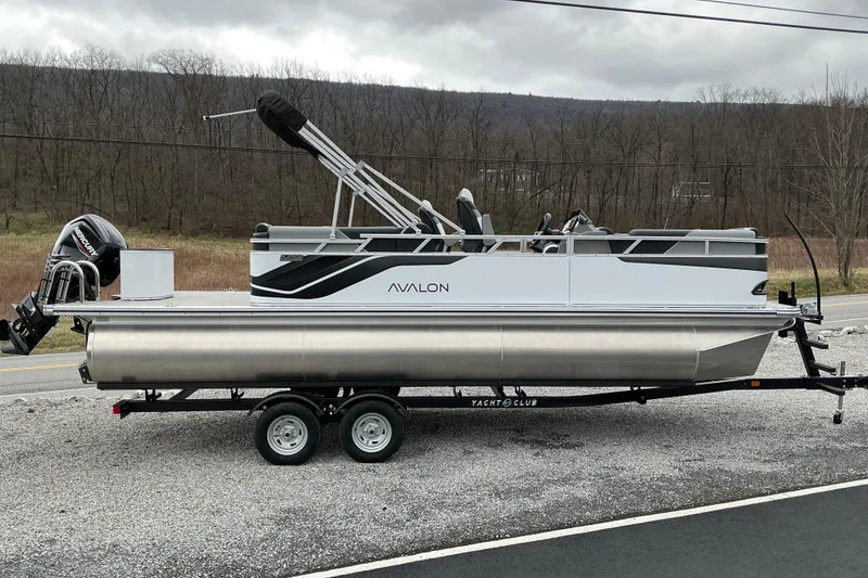 The Image of 2026 Avalon Venture 23 Quad Lounge pontoon boat on trailer, parked outdoors. - 1