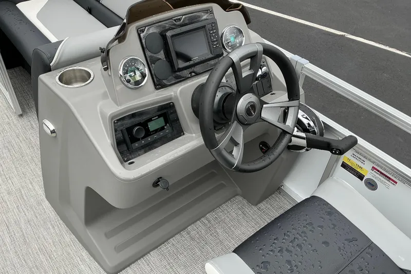Slide: The Image of Steering console of 2026 Avalon Venture 23 Quad Lounge pontoon boat with modern controls. - 8