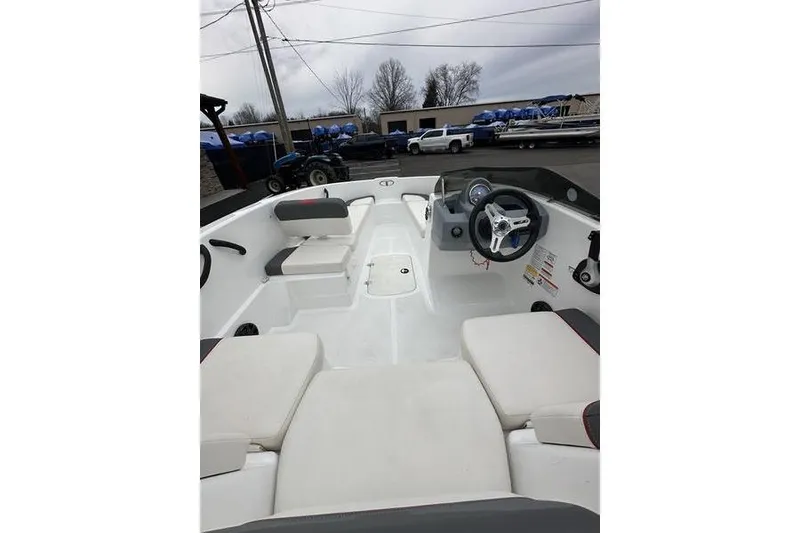 Slide: The Image of Interior view of a 2021 Tahoe T16 boat, featuring seating and steering wheel. - 11