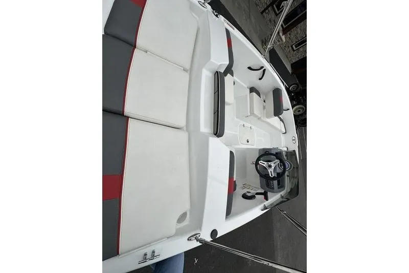 Slide: The Image of 2021 Tahoe T16 boat interior with white and gray seating, steering wheel, and controls. - 12