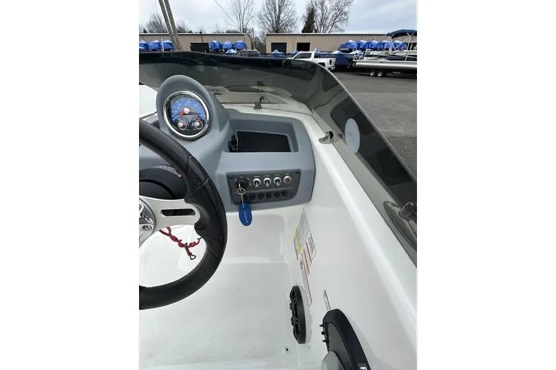 Slide: The Image of 2021 Tahoe T16 boat dashboard with steering wheel and control panel. - 13