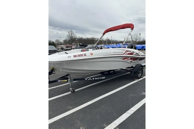 Slide: The Image of 2021 Tahoe T16 boat with red canopy on trailer in parking lot. - 3
