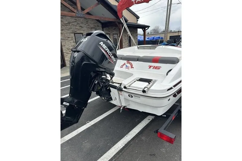 Slide: The Image of 2021 Tahoe T16 boat with Mercury outboard motor, parked on a trailer. - 5