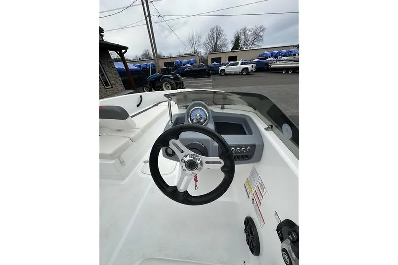 Slide: The Image of 2021 Tahoe T16 boat dashboard with steering wheel and control panel. - 8