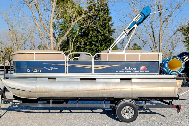 The Image of 2020 Sun Tracker Party Barge 18 pontoon boat on trailer, parked outdoors. - 0
