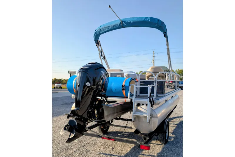 Slide: The Image of 2020 Sun Tracker Party Barge 18 pontoon boat with outboard motor and blue canopy. - 2
