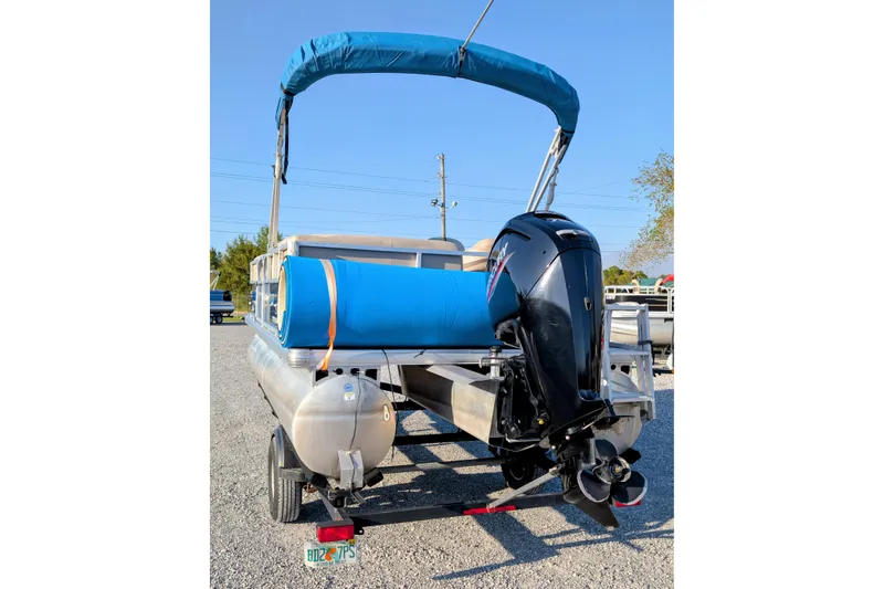 Slide: The Image of 2020 Sun Tracker Party Barge 18 pontoon boat with blue canopy and powerful outboard motor. - 3