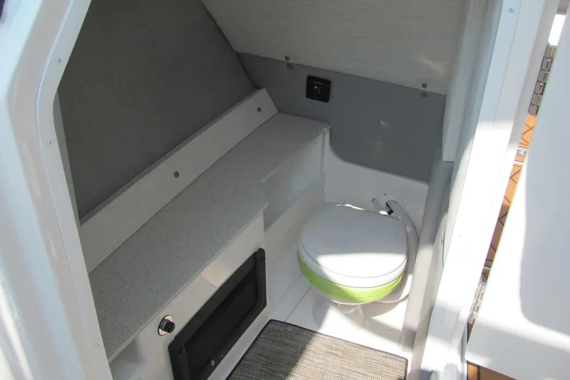 Slide: The Image of 2026 Cobalt R8 boat interior with compact toilet and storage area. - 13